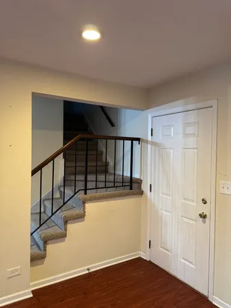 a view of entryway with stairs and wooden floor