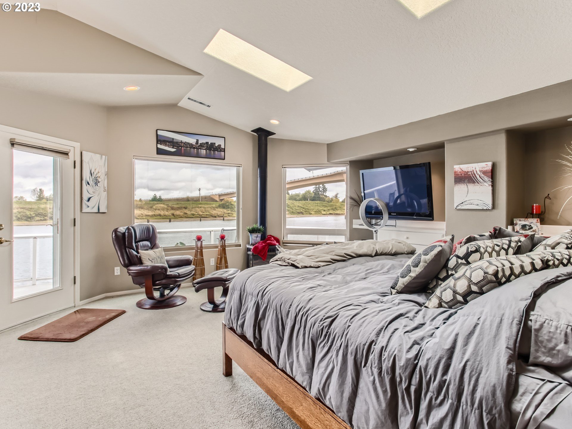 14565 Northwest Larson Road, Unit 15 Portland, OR 97231 - Photo 14 of 27 a bed room with a bed and large windows