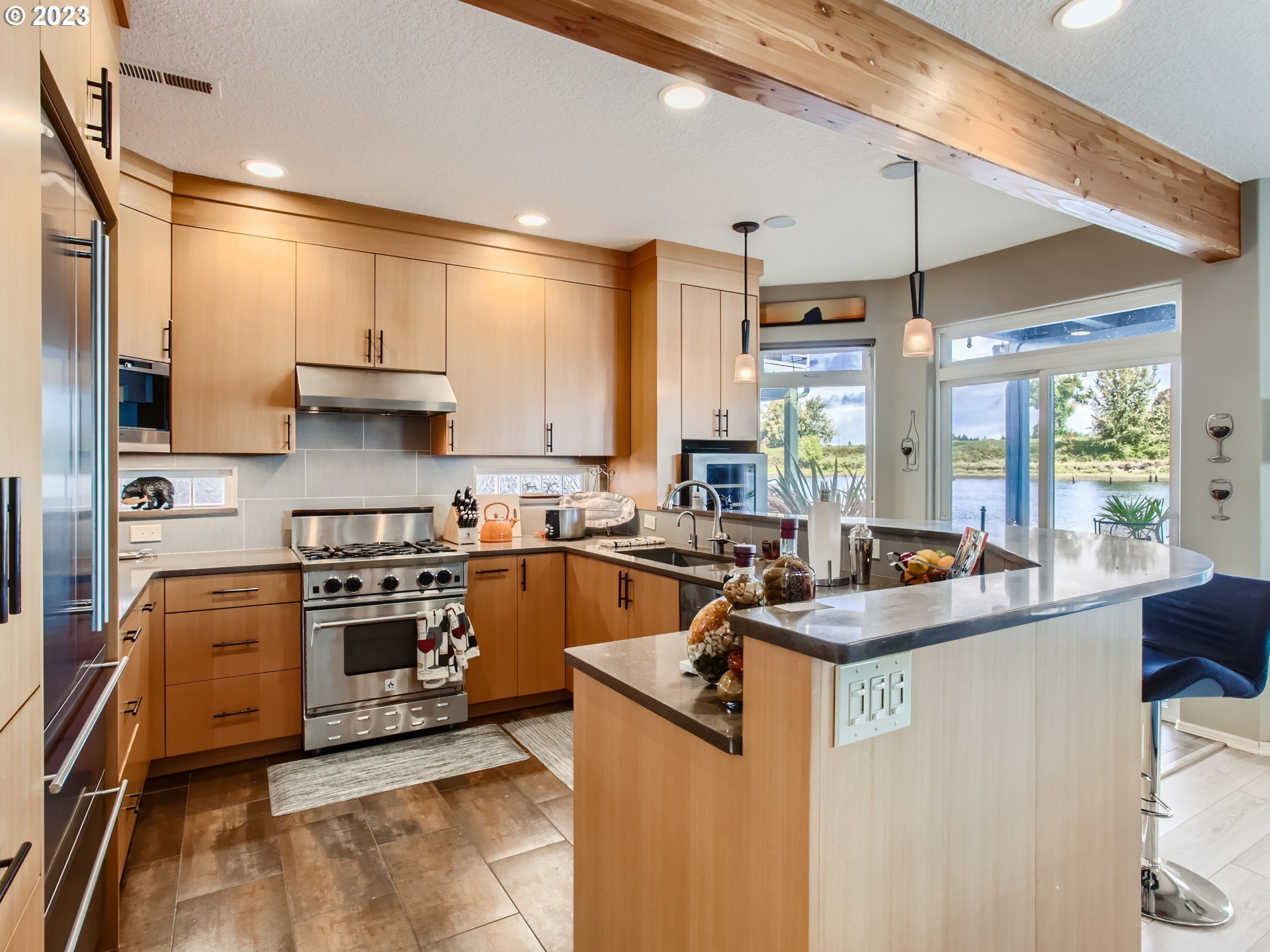 14565 Northwest Larson Road, Unit 15 Portland, OR 97231 - Photo 10 of 27 a kitchen with stainless steel appliances a sink a stove and a refrigerator