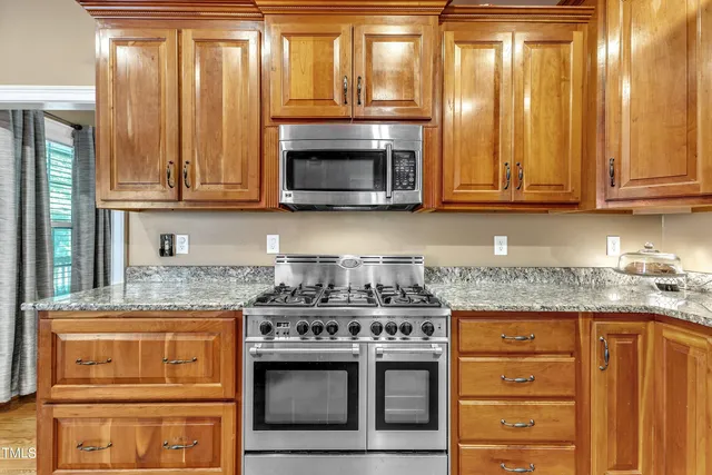 a stove top oven sitting inside of a kitchen