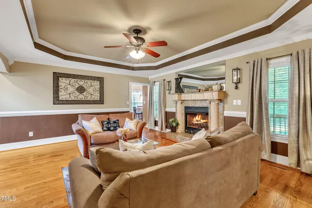 a bedroom with a bed a couch and a chandelier