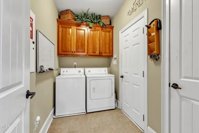 a en suite bathroom with a granite countertop double vanity sink and a mirror