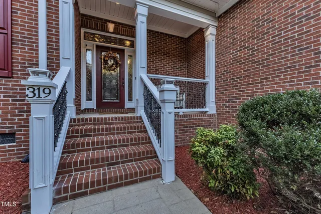 a view of a dining room with furniture a chandelier and wooden floor