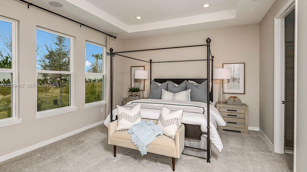 657 Southeast Ranch Oak Circle Port St. Lucie, FL 34984 - Photo 15 of 43 a bedroom with a bed and a window