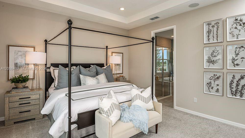 657 Southeast Ranch Oak Circle Port St. Lucie, FL 34984 - Photo 16 of 43 a bedroom with a bed and painting on the wall