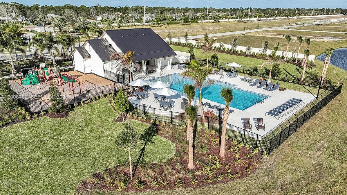 657 Southeast Ranch Oak Circle Port St. Lucie, FL 34984 - Photo 31 of 43 an aerial view of a house with a lake view