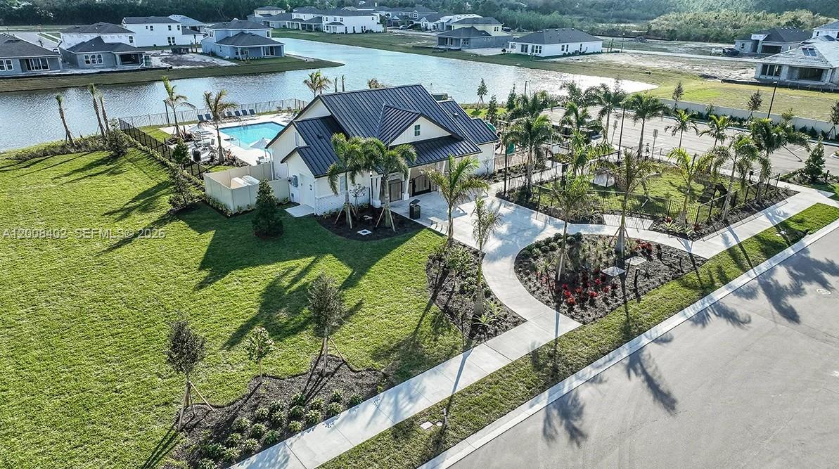 657 Southeast Ranch Oak Circle Port St. Lucie, FL 34984 - Photo 33 of 43 a view of swimming pool with outdoor seating and lake view
