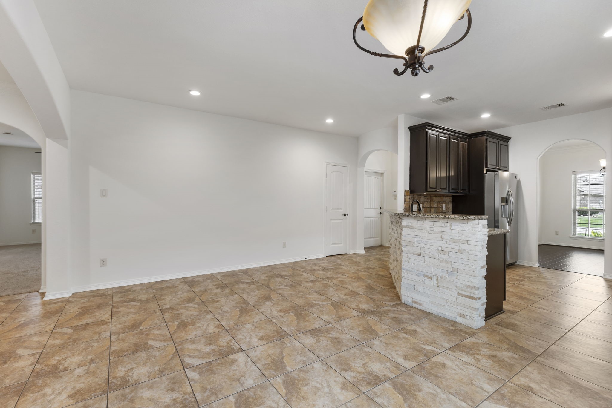23911 Augusta Falls Lane Spring, TX 77389 - Photo 11 of 40 a view of a kitchen with a sink and a refrigerator