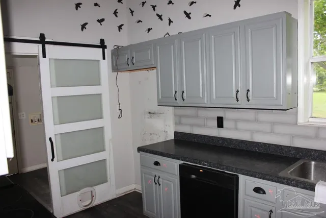 a kitchen with a sink and cabinets