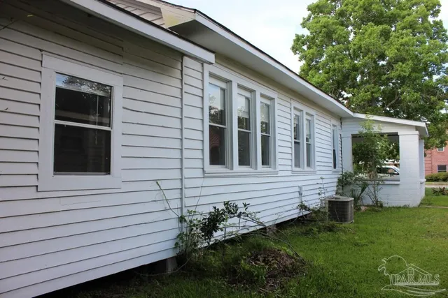 a view of house with backyard space and garden