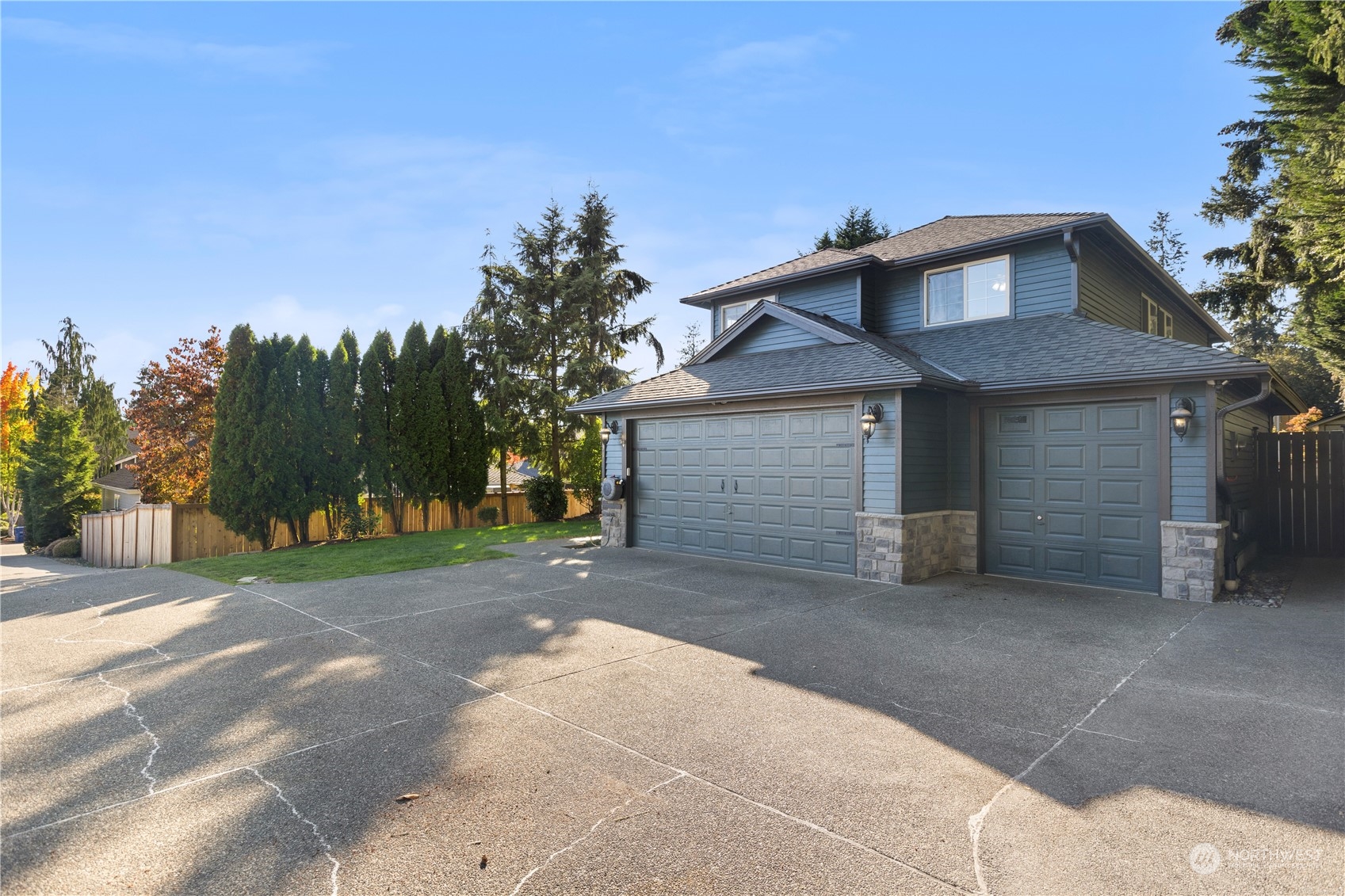 1431 241st Street Southeast Bothell, WA 98021 - Photo 3 of 40 a front view of a house with a yard and garage