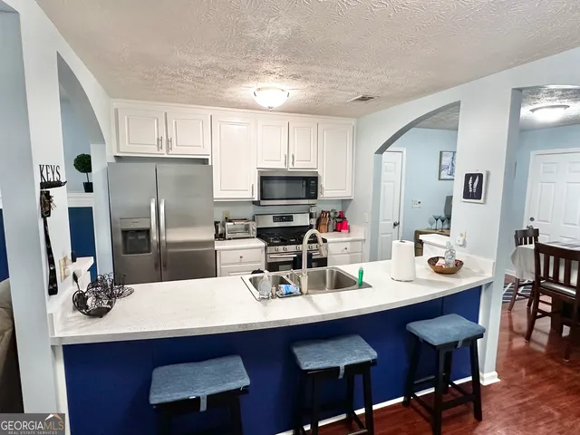 a kitchen with a sink cabinets and refrigerator