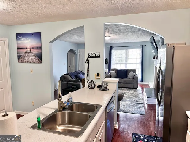 a kitchen that has a sink and a refrigerator