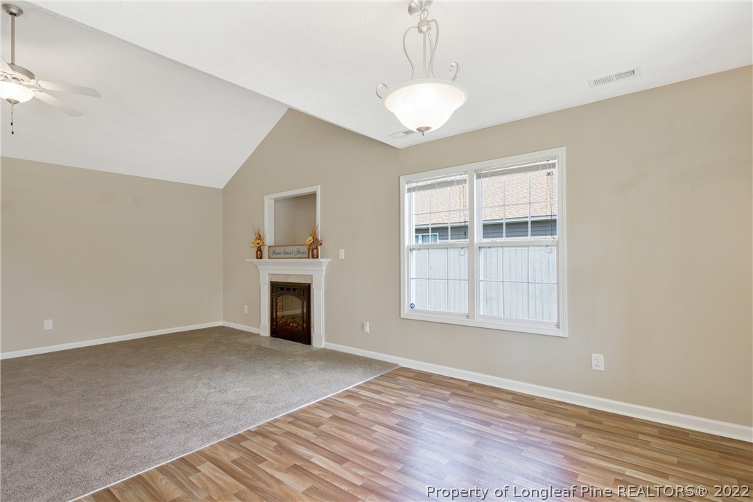 654 Hogart Street Raeford, NC 28376 - Photo 14 of 35 an empty room with windows and fireplace