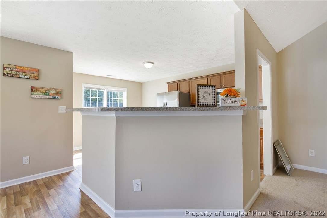 654 Hogart Street Raeford, NC 28376 - Photo 15 of 35 a kitchen with stainless steel appliances a sink and a refrigerator