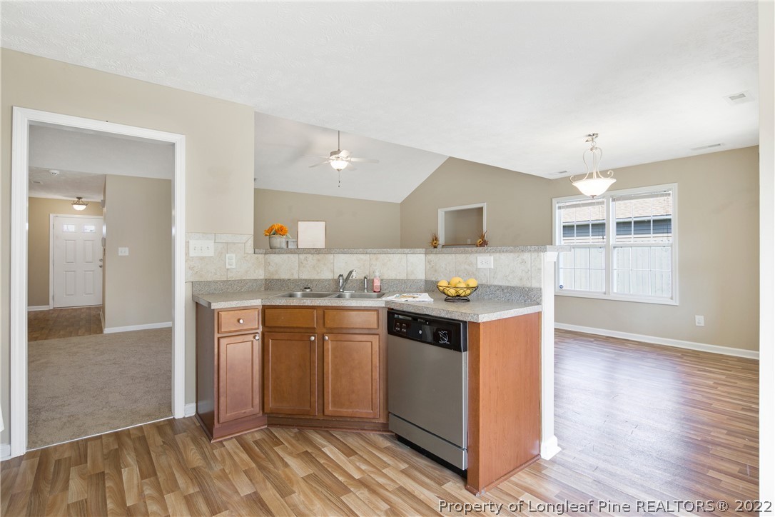 654 Hogart Street Raeford, NC 28376 - Photo 18 of 35 a kitchen with stainless steel appliances granite countertop a stove and a sink