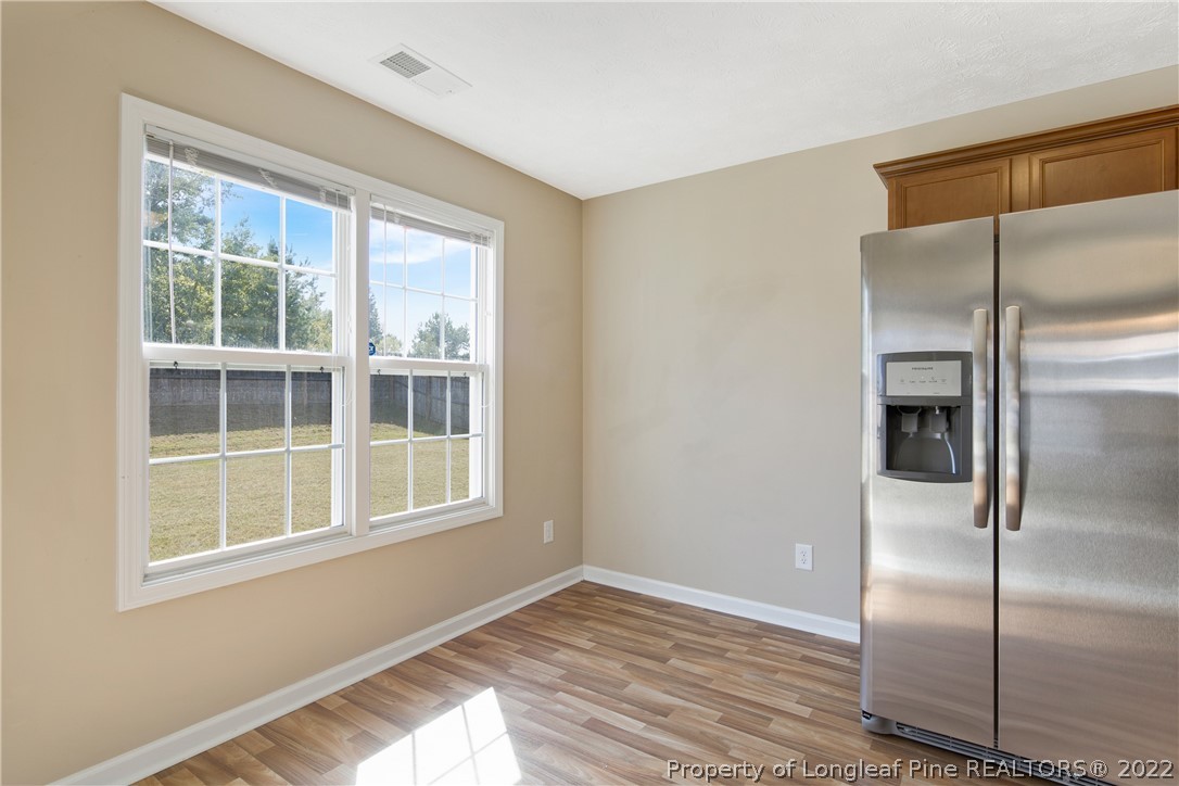 654 Hogart Street Raeford, NC 28376 - Photo 20 of 35 a view of an empty room with wooden floor and a window