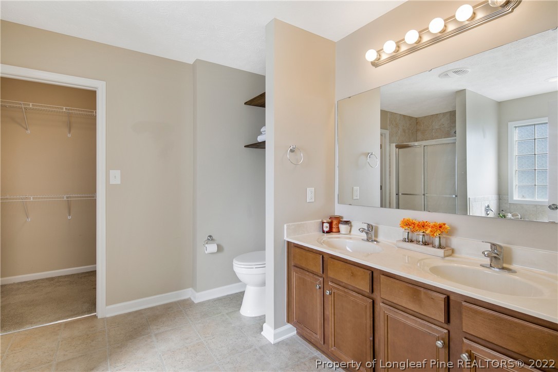 654 Hogart Street Raeford, NC 28376 - Photo 24 of 35 a bathroom with a sink double vanity granite tub and a mirror