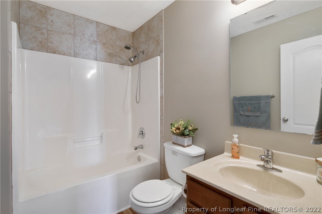 654 Hogart Street Raeford, NC 28376 - Photo 32 of 35 a bathroom with a sink toilet and shower