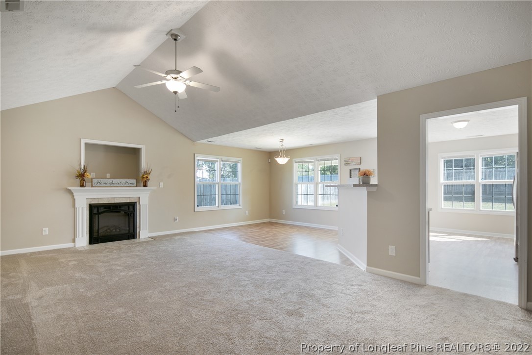 654 Hogart Street Raeford, NC 28376 - Photo 7 of 35 a view of an empty room with a fireplace and a window