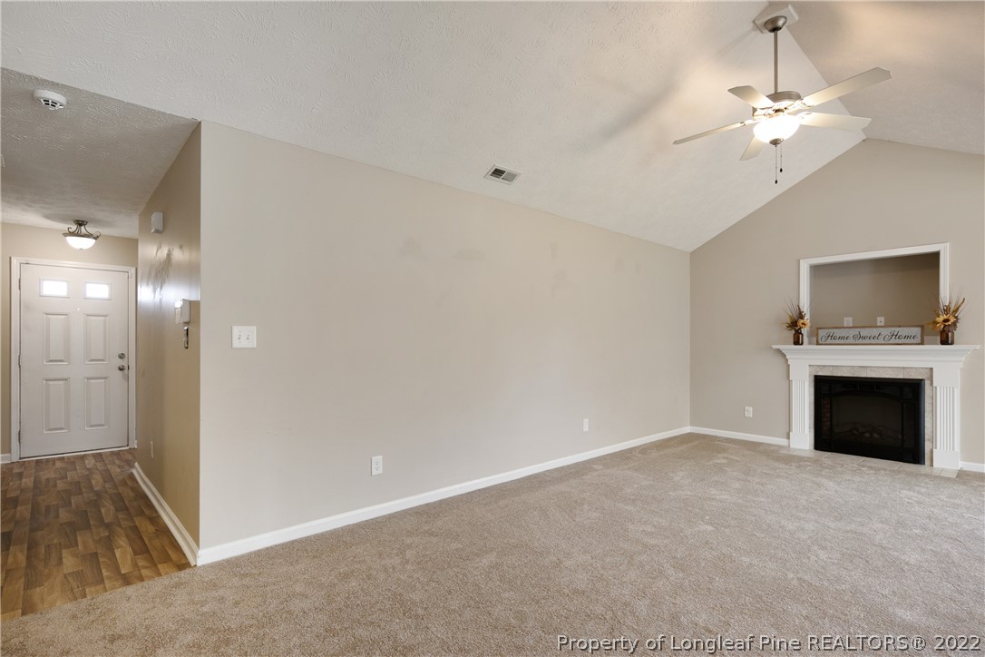 654 Hogart Street Raeford, NC 28376 - Photo 8 of 35 a view of an empty room with a fireplace