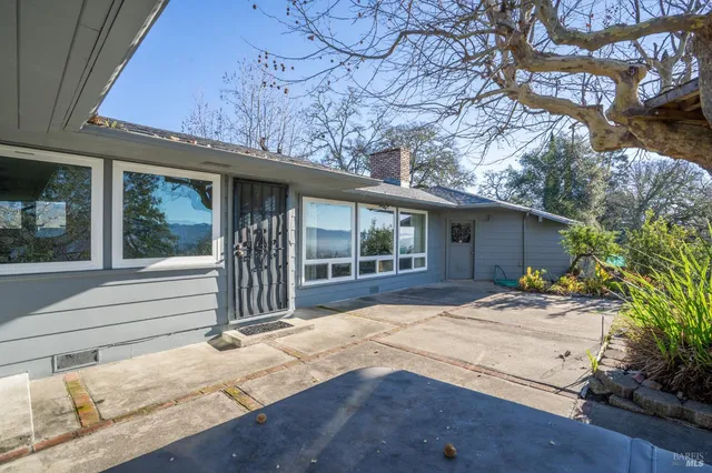 a view of a houses with a lush green forest