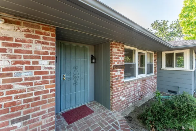 a large white kitchen with wooden floor