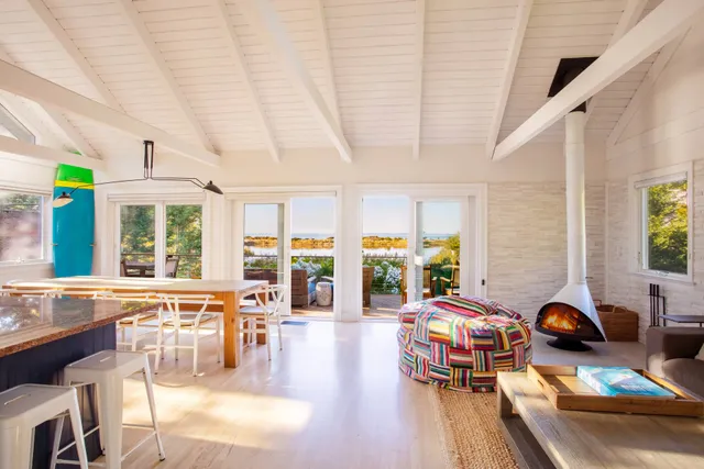 a living room with furniture and large windows