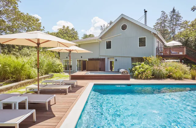 a front view of house with yard and outdoor seating