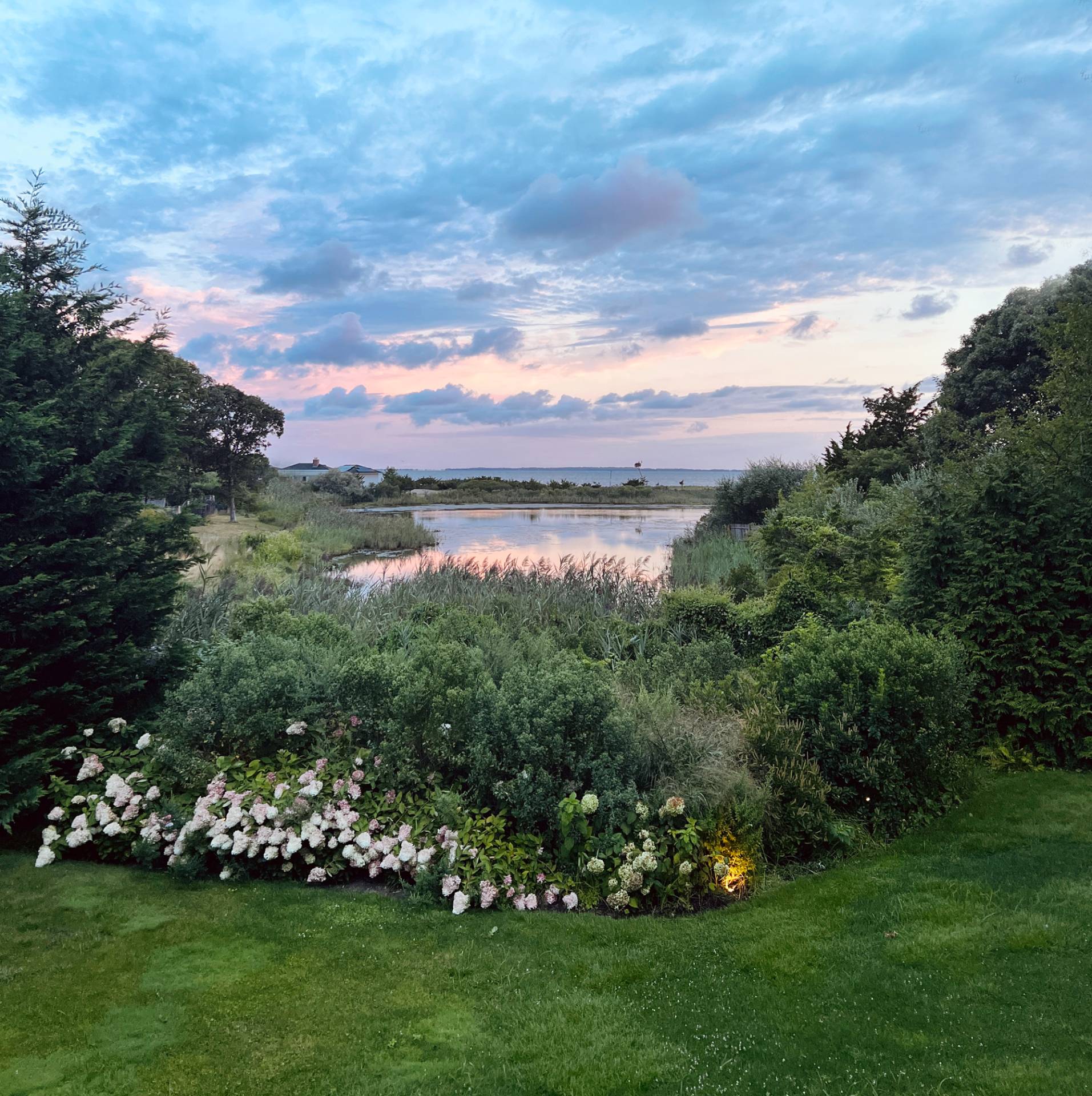 6 Bay Inlet Road East Hampton, NY 11937 - Photo 23 of 50 a view of a lake with a house in the background