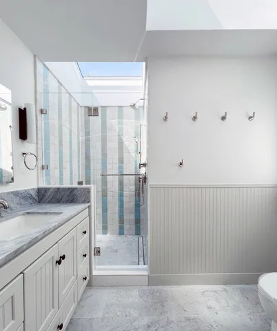 a bathroom with a sink vanity and mirror