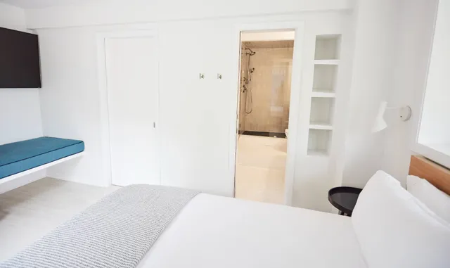 a bathroom with a sink a toilet a shower and a mirror