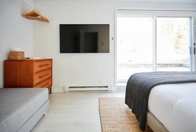 a bedroom with bed and a window