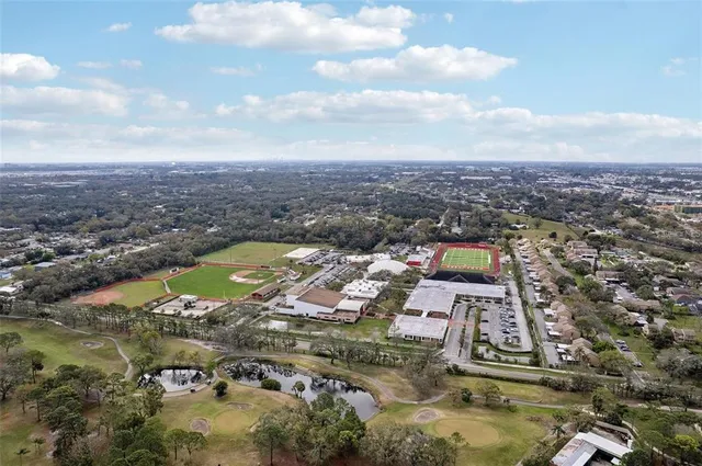 an aerial view of a residential houses with yard