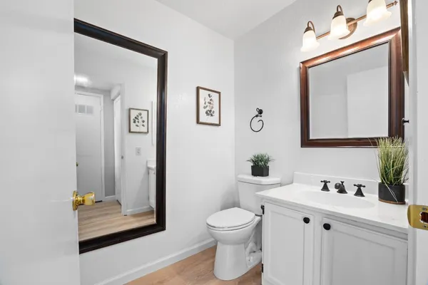 a bathroom with a toilet sink and mirror