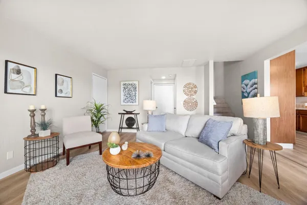 a living room with furniture a lamp and a window