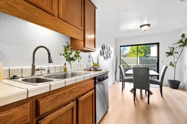 a kitchen with stainless steel appliances a table and chairs
