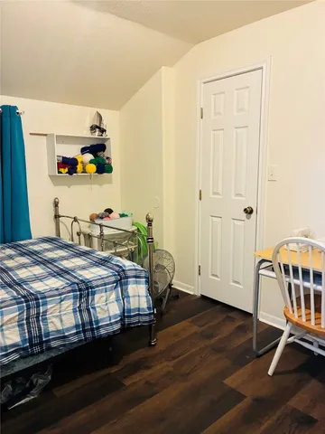 a bedroom with furniture and a window