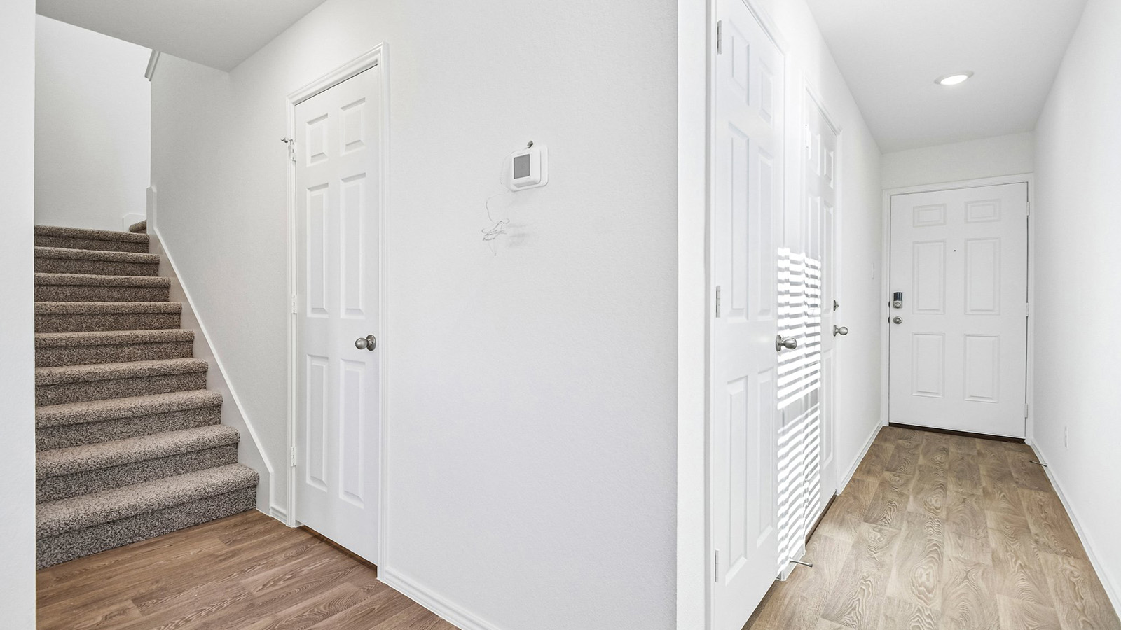 388 Old Stage Coach Road Jarrell, TX 76537 - Photo 2 of 30 Crisp walls and wood-look flooring define this welcoming entrance hall and staircase.