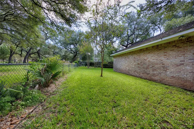 a view of a backyard with a wooden fence