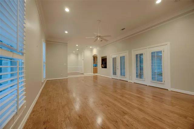 a view of a livingroom with wooden floor and staircase