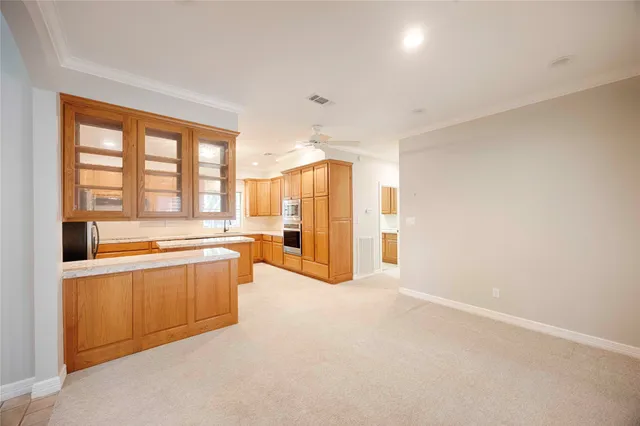 a large white kitchen with a large window