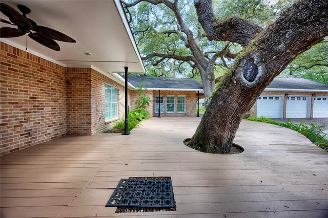a white house that has a tree in front of it