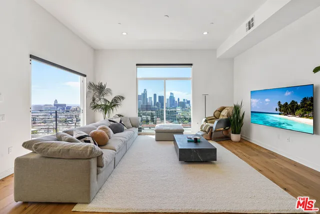 a living room with furniture and a floor to ceiling window