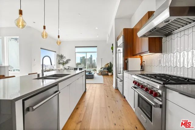 a kitchen with granite countertop a sink stove and cabinets