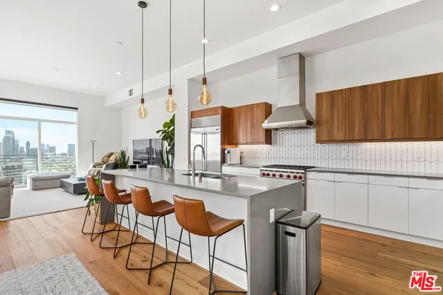 a kitchen with stainless steel appliances granite countertop sink stove top oven and cabinets