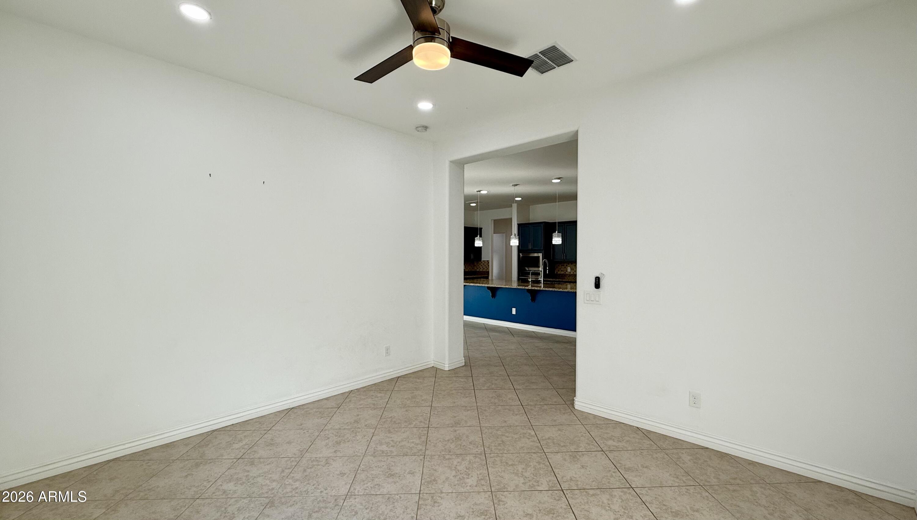 3355 East Constance Way Phoenix, AZ 85042 - Photo 11 of 42 an empty room and chandelier fan