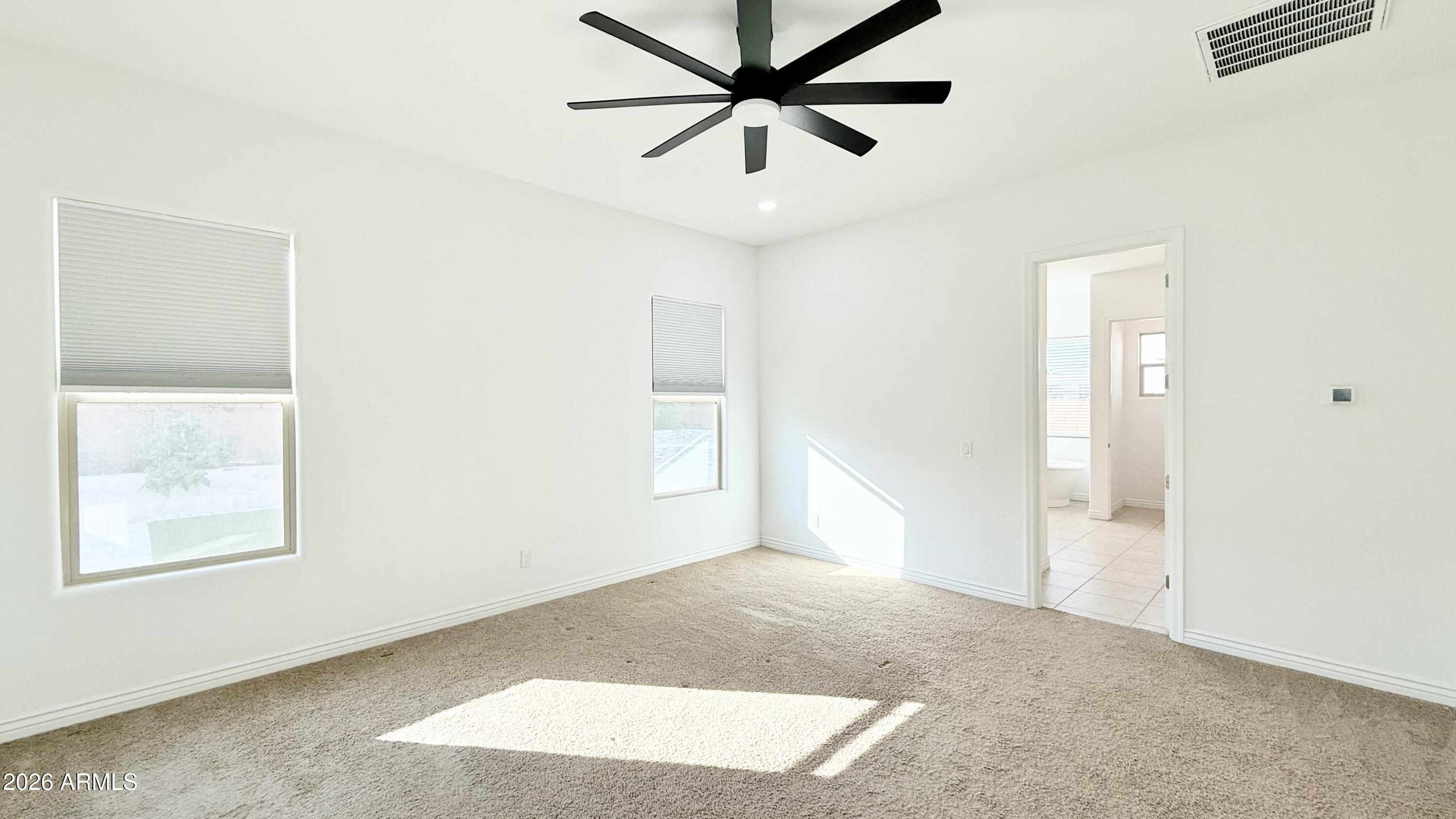 3355 East Constance Way Phoenix, AZ 85042 - Photo 23 of 42 an empty room with windows and fan