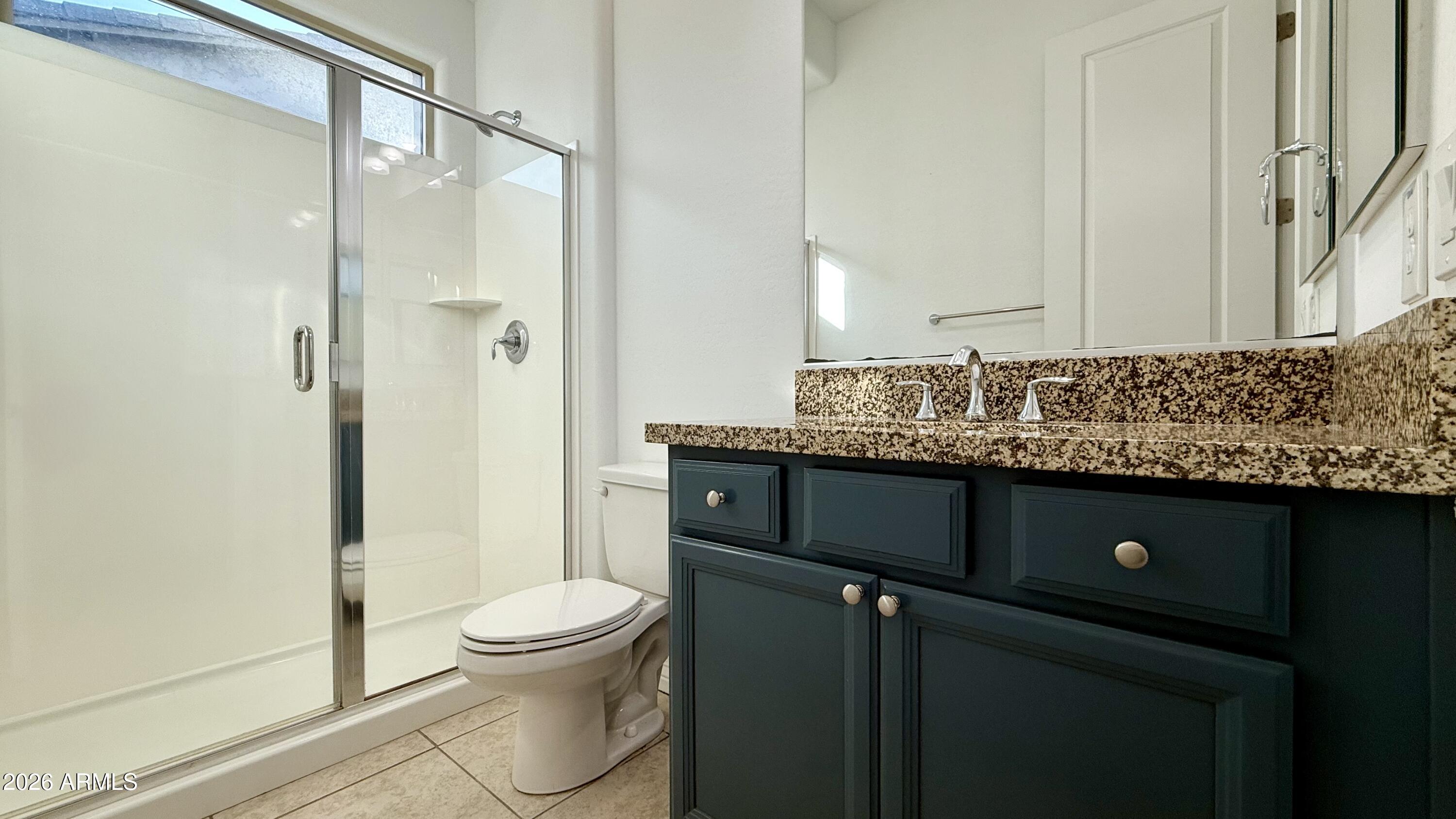 3355 East Constance Way Phoenix, AZ 85042 - Photo 28 of 42 a bathroom with a sink a toilet and shower