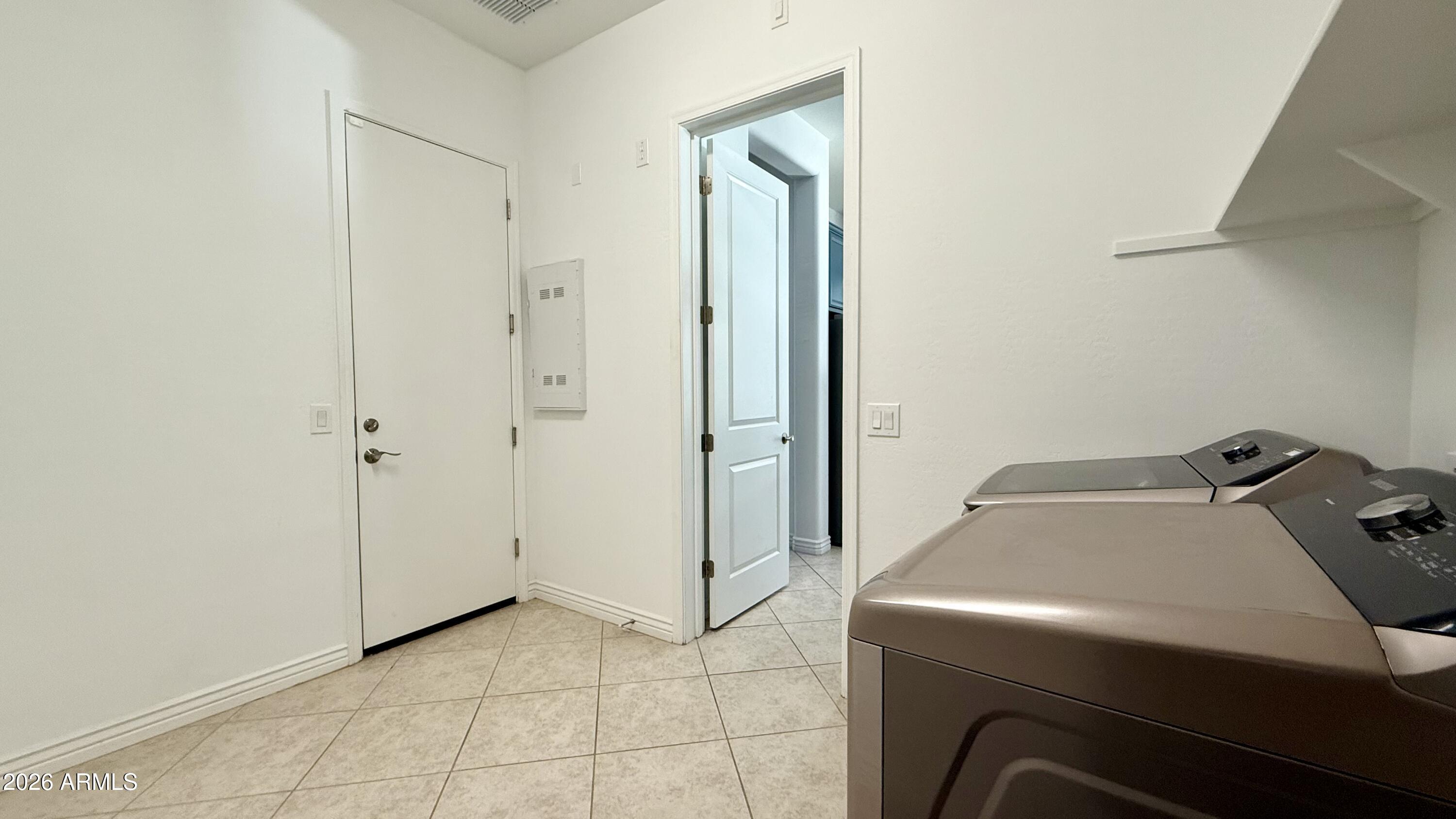 3355 East Constance Way Phoenix, AZ 85042 - Photo 32 of 42 a utility room with cabinets washer and dryer